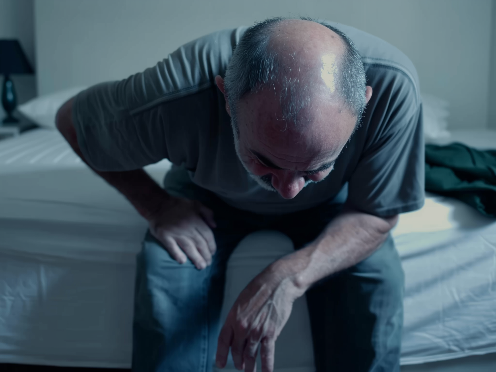 Path 1 — man in pain, sitting on edge of bed
