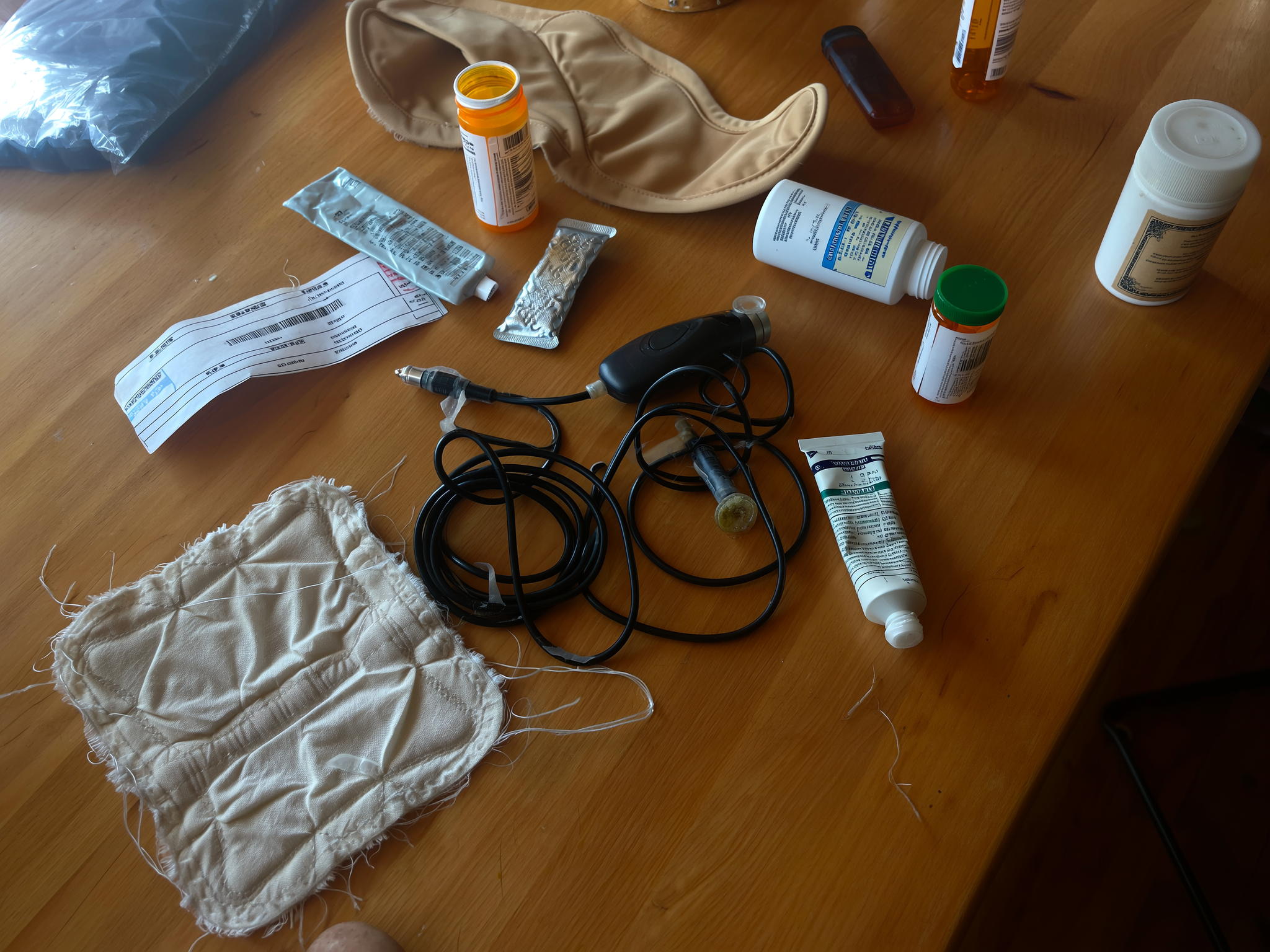 Pile of medications, heating pads, and TENS unit
